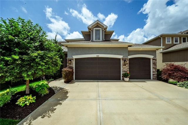 16600 Eby St, Overland Park, KS 66085 - view of front of home with stucco siding, an attached garage, driveway, and stone siding