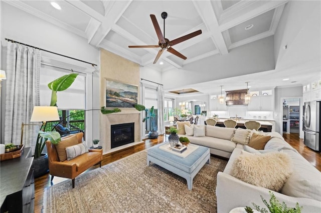 16600 Eby St, Overland Park, KS 66085 - living area with coffered ceiling, ceiling fan, a towering ceiling, dark wood finished floors, and beamed ceiling