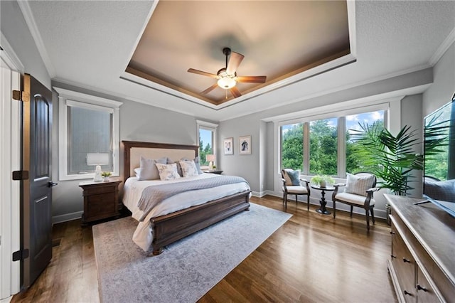 16600 Eby St, Overland Park, KS 66085 - bedroom featuring a raised ceiling, crown molding, dark wood-style floors, and ceiling fan