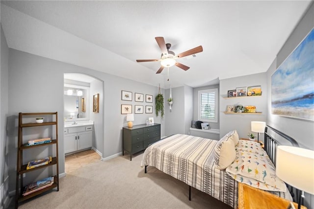 16600 Eby St, Overland Park, KS 66085 - bedroom with light colored carpet, arched walkways, ensuite bathroom, and ceiling fan