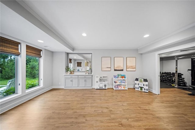 16600 Eby St, Overland Park, KS 66085 - unfurnished living room featuring ornamental molding, recessed lighting, and light wood-type flooring
