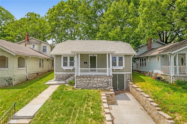 5016 Lydia Ave, Kansas City, MO 64110 - bungalow featuring a porch, a front yard, stairs, and a shingled roof