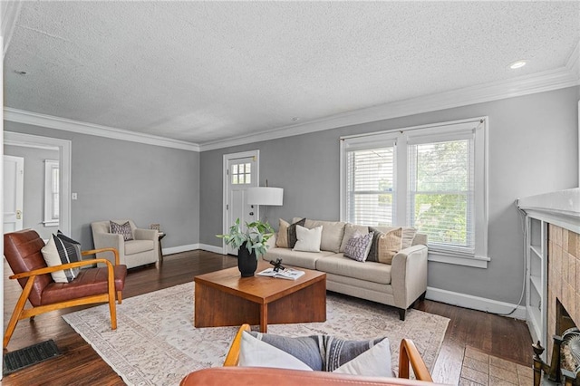 5016 Lydia Ave, Kansas City, MO 64110 - living area featuring a textured ceiling, dark wood finished floors, a tiled fireplace, ornamental molding, and recessed lighting