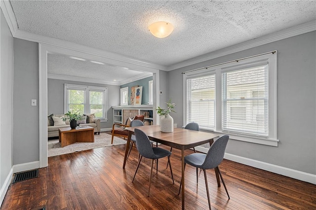 5016 Lydia Ave, Kansas City, MO 64110 - dining area with a textured ceiling, dark wood finished floors, and crown molding