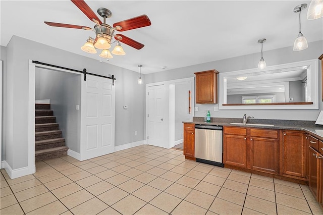 5016 Lydia Ave, Kansas City, MO 64110 - kitchen featuring stainless steel dishwasher, a ceiling fan, a barn door, dark countertops, and decorative light fixtures