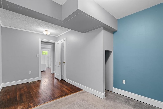 5016 Lydia Ave, Kansas City, MO 64110 - spare room with a textured ceiling and wood finished floors