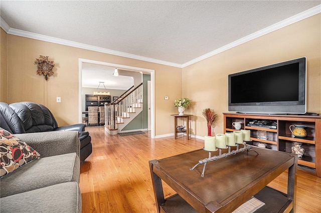 9412 Delmar St, Prairie Village, KS 66207 - living room with stairway, wood finished floors, crown molding, a textured ceiling, and a chandelier