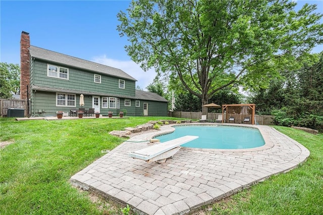 9412 Delmar St, Prairie Village, KS 66207 - view of swimming pool featuring a diving board, a patio, and a fenced backyard
