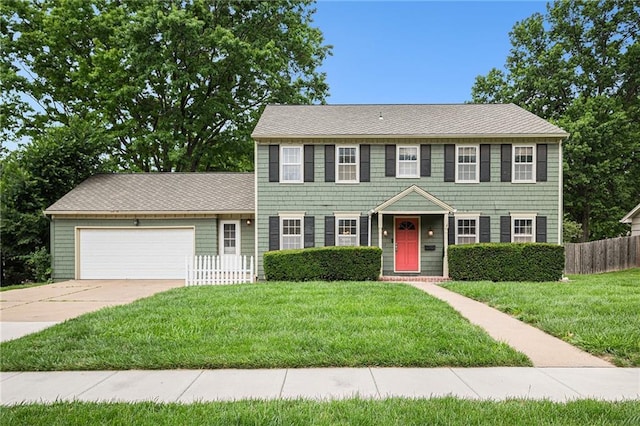 9412 Delmar St, Prairie Village, KS 66207 - colonial home featuring a garage and concrete driveway