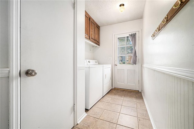 9412 Delmar St, Prairie Village, KS 66207 - laundry area featuring washer and clothes dryer, cabinet space, wainscoting, light tile patterned floors, and a textured ceiling