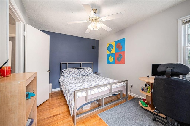 9412 Delmar St, Prairie Village, KS 66207 - bedroom with wood finished floors, a desk, ceiling fan, and a textured ceiling