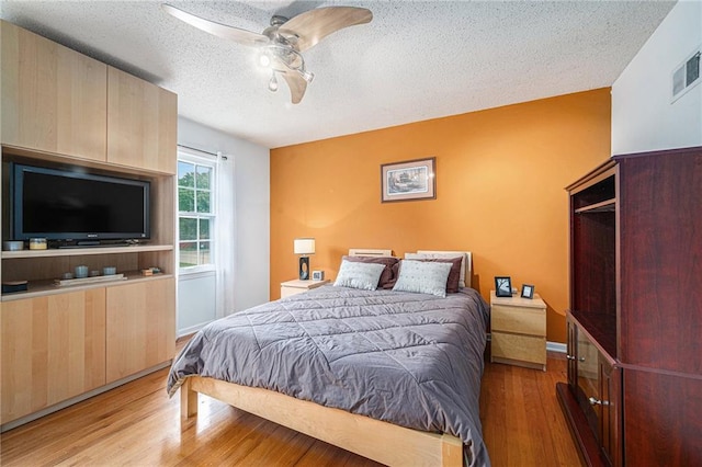 9412 Delmar St, Prairie Village, KS 66207 - bedroom with a textured ceiling, light wood-style floors, and a ceiling fan