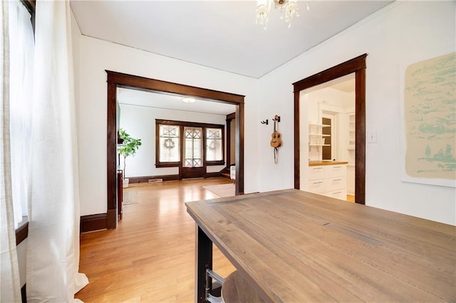 3029 E 7th St, Kansas City, MO 64124 - corridor with light wood-type flooring and a chandelier