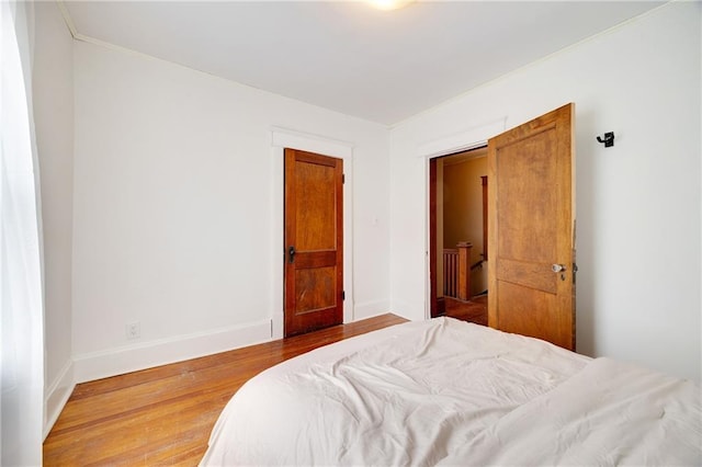3029 E 7th St, Kansas City, MO 64124 - bedroom with wood finished floors and baseboards