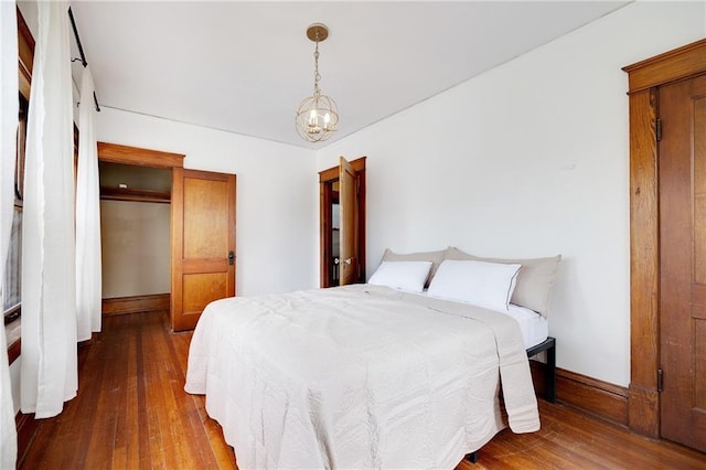3029 E 7th St, Kansas City, MO 64124 - bedroom featuring hardwood / wood-style floors and a chandelier