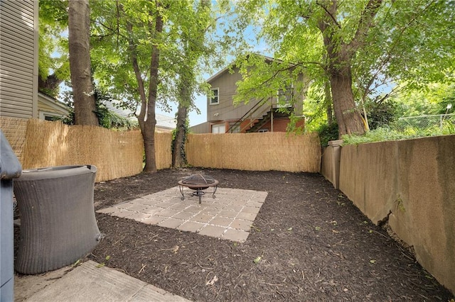 3029 E 7th St, Kansas City, MO 64124 - fenced backyard featuring a fire pit and a patio