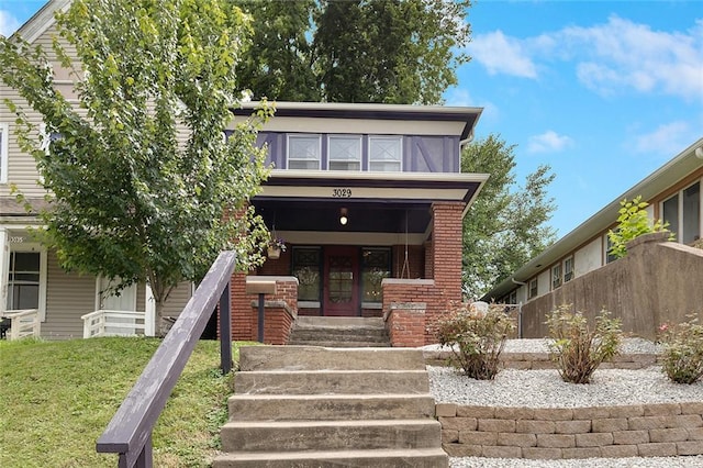 3029 E 7th St, Kansas City, MO 64124 - view of front of property featuring brick siding, french doors, and a front lawn