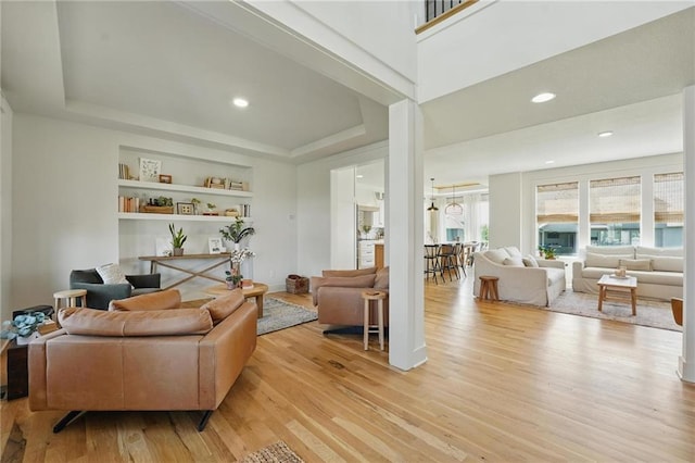 16555 S Lichtenauer Dr, Olathe, KS 66062 - living room featuring a raised ceiling, light wood finished floors, and recessed lighting
