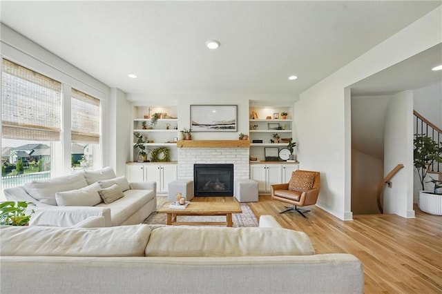16555 S Lichtenauer Dr, Olathe, KS 66062 - living area with light wood-style flooring, stairs, a fireplace, and recessed lighting