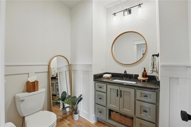 16555 S Lichtenauer Dr, Olathe, KS 66062 - bathroom featuring vanity, wood finished floors, and a wainscoted wall