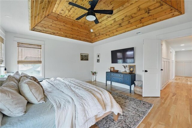 16555 S Lichtenauer Dr, Olathe, KS 66062 - bedroom featuring wood ceiling, light wood-type flooring, a tray ceiling, and a ceiling fan
