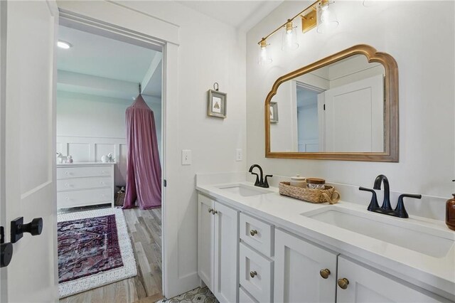 16555 S Lichtenauer Dr, Olathe, KS 66062 - bathroom featuring double vanity and wood finished floors