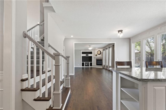17940 W 158th Ct, Olathe, KS 66062 - interior space with a textured ceiling, stairs, dark wood finished floors, and ceiling fan