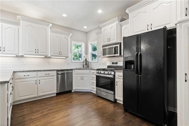 17940 W 158th Ct, Olathe, KS 66062 - kitchen featuring appliances with stainless steel finishes, white cabinetry, recessed lighting, light stone counters, and backsplash