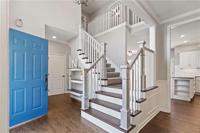 17940 W 158th Ct, Olathe, KS 66062 - entryway featuring dark wood-style flooring, stairs, ornamental molding, and a textured ceiling