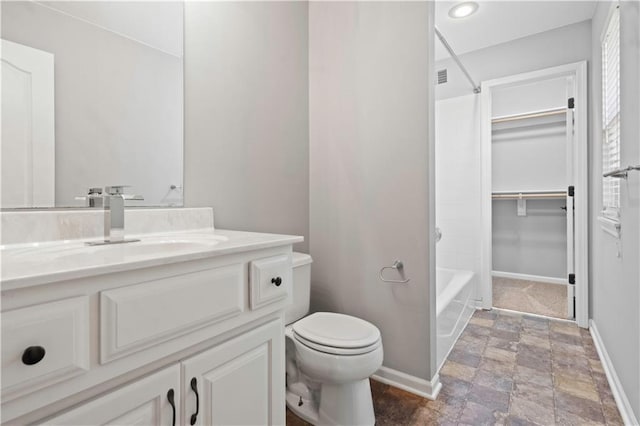 17940 W 158th Ct, Olathe, KS 66062 - bathroom featuring vanity, stone finish floors, washtub / shower combination, a walk in closet, and recessed lighting