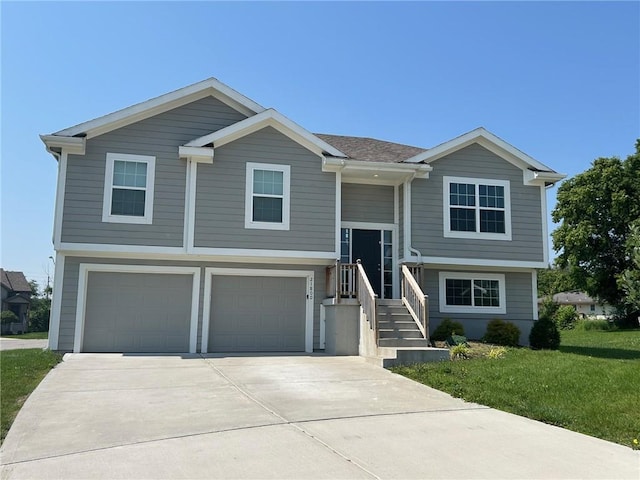 21800 Southcreek Rd, Peculiar, MO 64078 - bi-level home featuring a garage, concrete driveway, and a front yard
