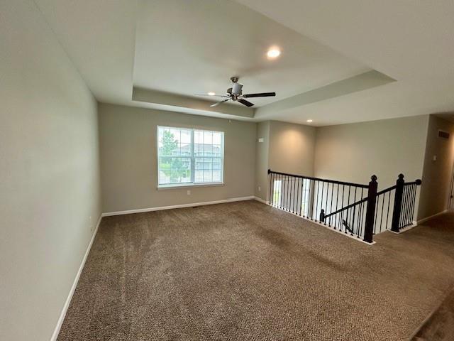 21800 Southcreek Rd, Peculiar, MO 64078 - carpeted spare room with a tray ceiling, ceiling fan, and recessed lighting