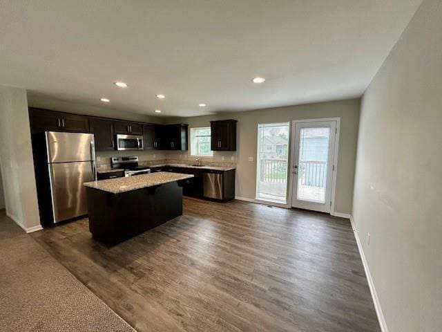 21800 Southcreek Rd, Peculiar, MO 64078 - kitchen with stainless steel appliances, a center island, dark wood-style floors, light countertops, and recessed lighting