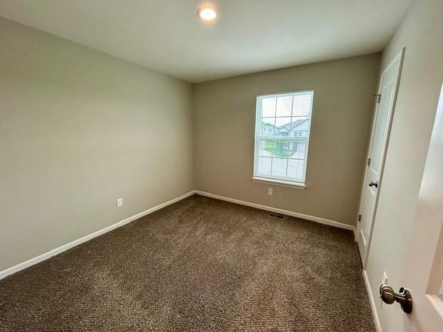 21800 Southcreek Rd, Peculiar, MO 64078 - spare room with dark colored carpet and recessed lighting
