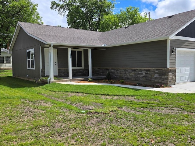 822 Carolina St, Neodesha, KS 66757 - single story home with covered porch, a front lawn, an attached garage, roof with shingles, and stone siding