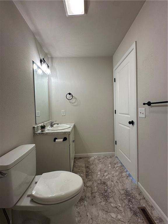 822 Carolina St, Neodesha, KS 66757 - bathroom featuring toilet and vanity