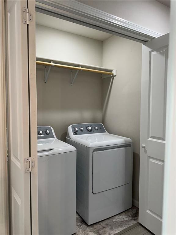 822 Carolina St, Neodesha, KS 66757 - laundry area with separate washer and dryer and wood finished floors