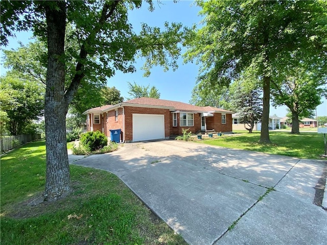 311 SW 12th Ter, Concordia, MO 64020 - ranch-style house with brick siding, a garage, and driveway