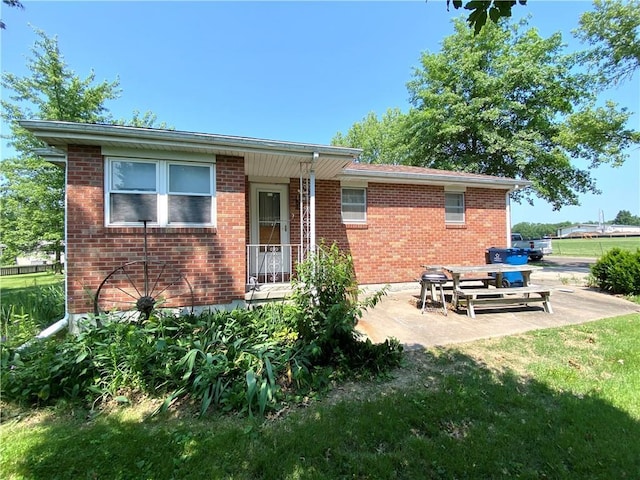 311 SW 12th Ter, Concordia, MO 64020 - back of property featuring brick siding and a patio
