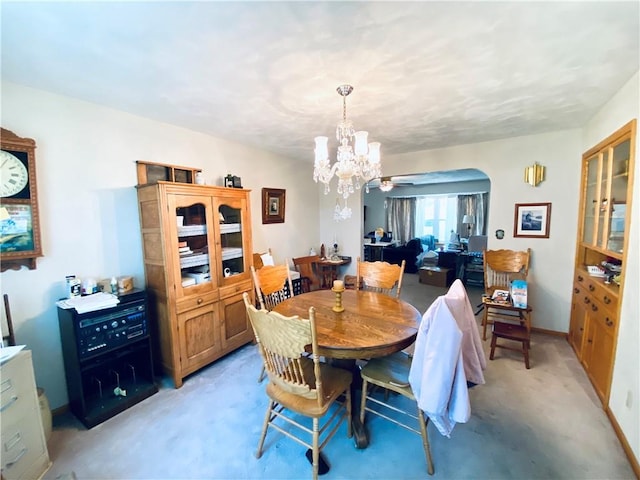 311 SW 12th Ter, Concordia, MO 64020 - dining space with a chandelier, arched walkways, and light carpet