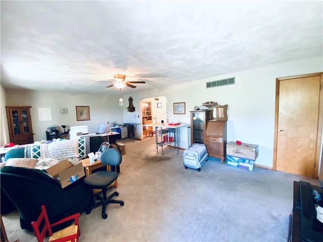 311 SW 12th Ter, Concordia, MO 64020 - living room featuring carpet floors, ceiling fan, and arched walkways