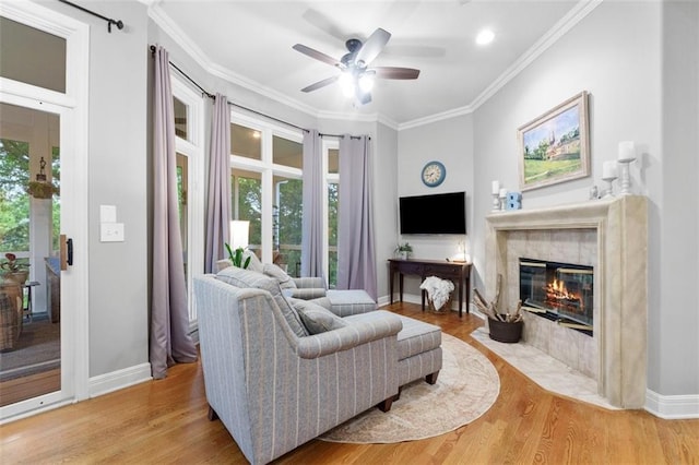 10181 S Shadow Cir, Olathe, KS 66061 - living room featuring light wood finished floors, a fireplace with flush hearth, ceiling fan, and ornamental molding