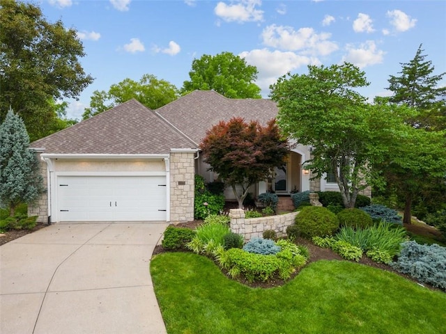 10181 S Shadow Cir, Olathe, KS 66061 - view of front of home featuring concrete driveway, an attached garage, a shingled roof, stone siding, and a front yard