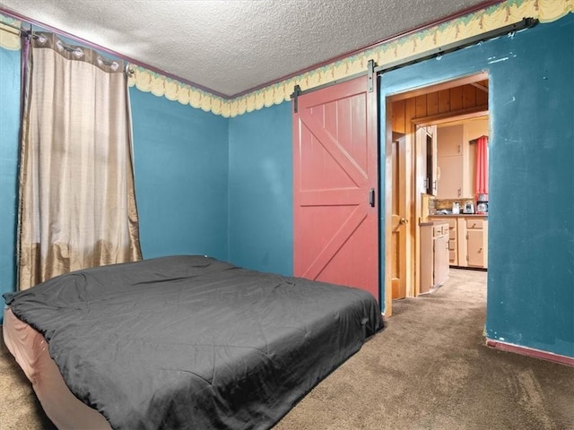 2605 S 15th St, Saint Joseph, MO 64503 - bedroom with carpet, a textured ceiling, and a barn door