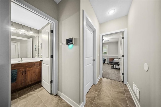 14115 NW 68th St, Parkville, MO 64152 - corridor featuring baseboards and a sink