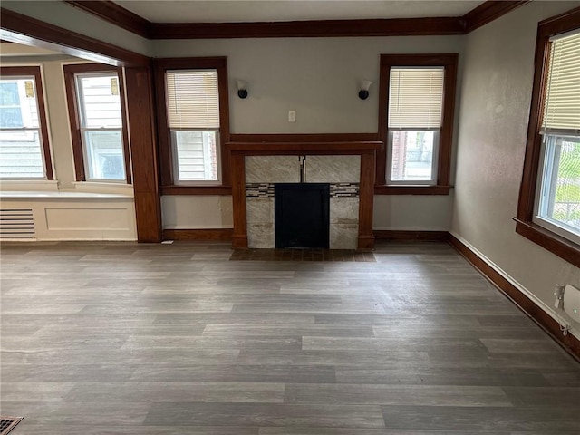 3307 Askew Ave, Kansas City, MO 64128 - unfurnished living room featuring crown molding, wood finished floors, and a fireplace
