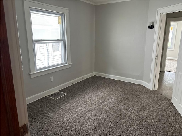 3307 Askew Ave, Kansas City, MO 64128 - unfurnished room featuring plenty of natural light and dark carpet