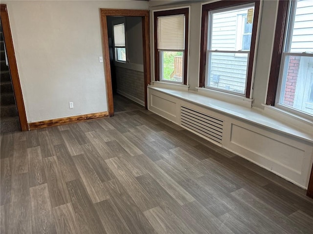 3307 Askew Ave, Kansas City, MO 64128 - empty room featuring dark wood-style floors and plenty of natural light