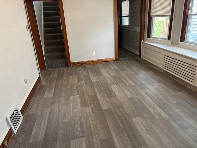 3307 Askew Ave, Kansas City, MO 64128 - empty room featuring wood finished floors and stairway
