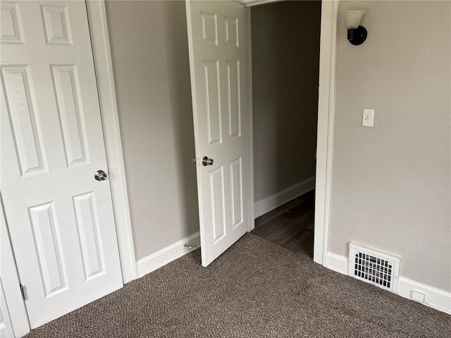 3307 Askew Ave, Kansas City, MO 64128 - unfurnished bedroom featuring dark colored carpet and baseboards